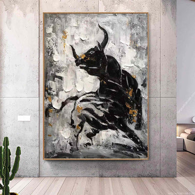 Abstract painting of a black bull on a gray wall in a modern interior setting.