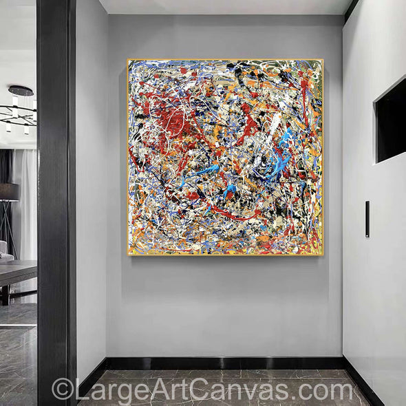 A large abstract oil painting on canvas displayed on a wall, with a colorful, chaotic pattern of brush strokes filling the space.